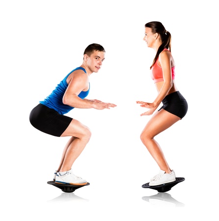 Young beautiful model with fitness balance boardの写真素材