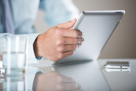 Businessman uses the new media technologies and devices to work successfullyの写真素材