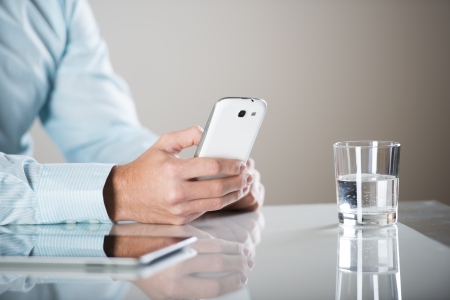 Businessman uses the new media technologies and devices to work successfullyの写真素材