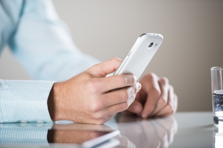 Businessman uses the new media technologies and devices to work successfullyの写真素材