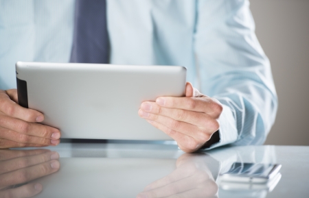 Businessman uses the new media technologies and devices to work successfullyの写真素材