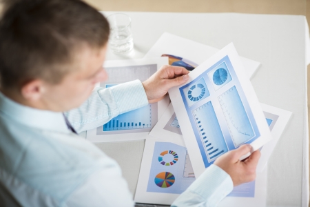 Business people reading business graphs and chartsの写真素材