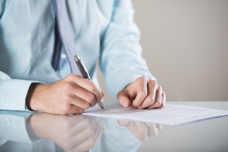 Businessman is signing a contract, business contract detailsの写真素材