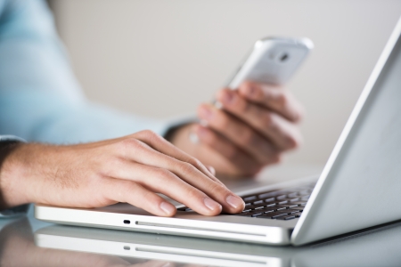 Businessman uses the new media technologies and devices to work successfullyの写真素材