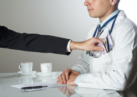 Closeup on medical doctor hands, taking moneyの写真素材