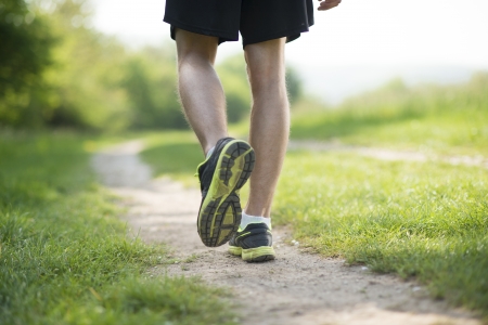 Young man is running in sunny natureの写真素材