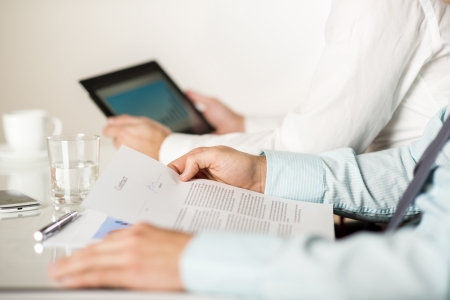 Business people reading business graphs and chartsの写真素材