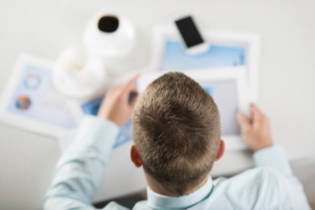 Business people reading business graphs and chartsの写真素材