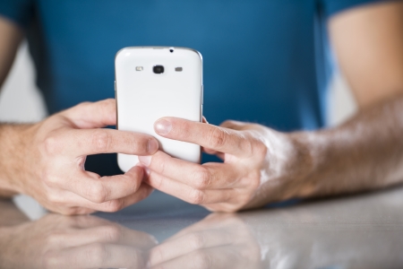 Close up of a man using mobile smart phoneの写真素材