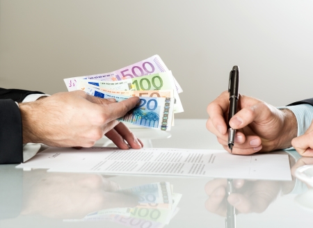 Businessmen are signing a contract, business contract detailsの写真素材
