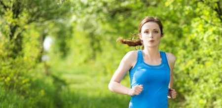 Pretty young girl runner in the forestの写真素材