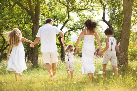 Happy young family spending time outdoor on a summer dayの写真素材