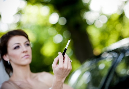 Happy bride and groom in a black car on wedding dayの写真素材