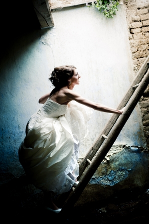 Lovely and happy brunette bride posing outdoorの写真素材