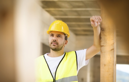 Construction worker is working on new house
