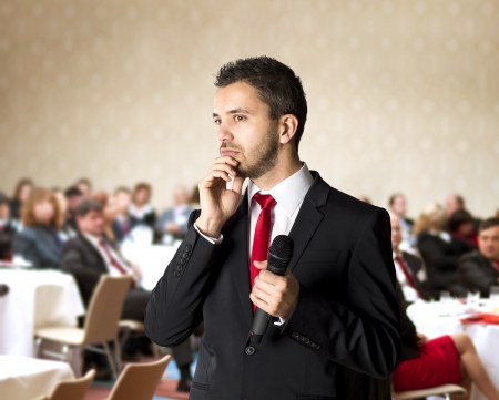 Man is speaking on indoor business conference for managers の写真素材