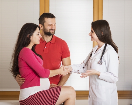 Young pregnant woman with doctor in ambulance の写真素材