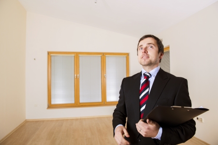 Real Estate Agent is standing in new empty house の写真素材