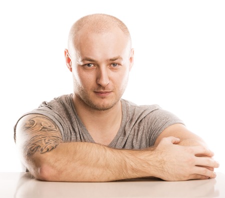 Handsome young man with tattoo, isolated on white の写真素材