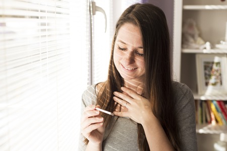 Woman with pregnancy test