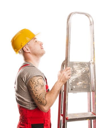 Construction worker in a protective helmet isolated over white backgroundの写真素材