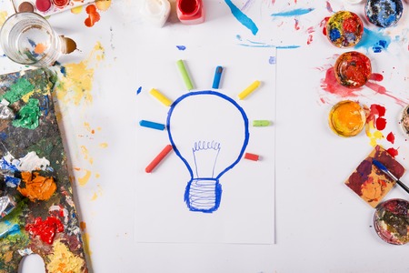 Creative idea concept with colorful paints over white paper