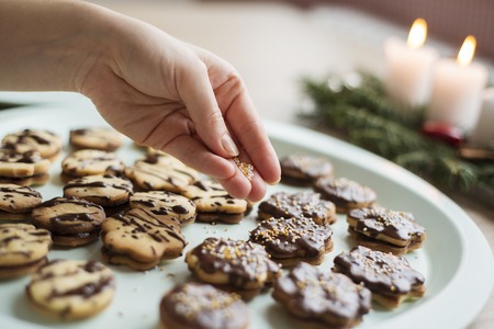 Woman is making christmas cakes in the kitchen