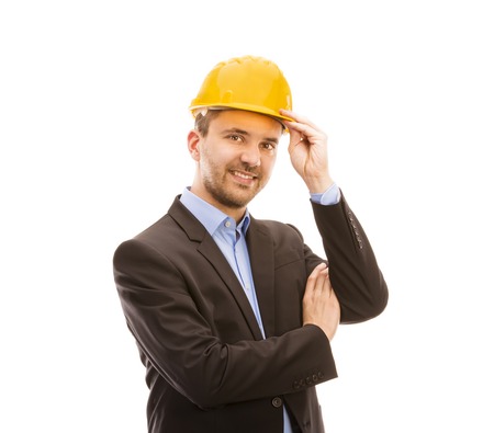 Young engineer with yellow helmet is isolated on white background の写真素材