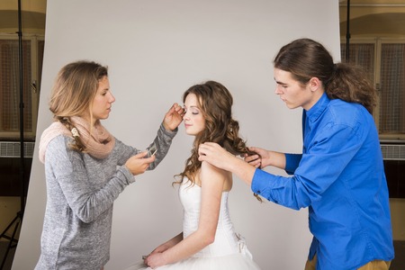 Studio portraits with beautiful bride makeup artist and hairdresserの写真素材