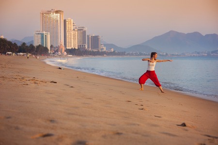 Sport active woman stretching and exercising at the city beach の写真素材