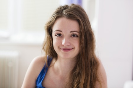 Beautiful woman is lying on the bed の写真素材