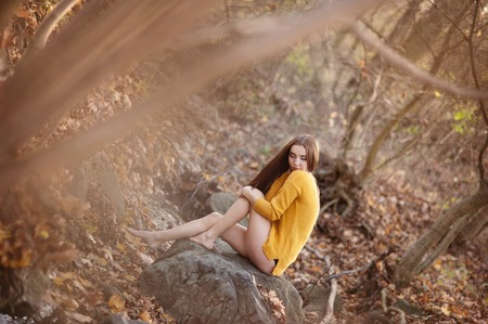 Outdoor portrait of beautiful girl in autumn forestの写真素材