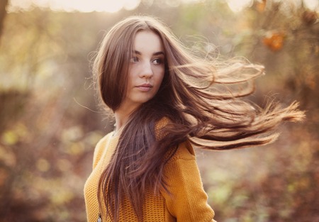Outdoor portrait of beautiful girl in autumn forestの写真素材