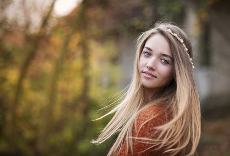 Outdoor portrait of beautiful girl in autumn forestの写真素材