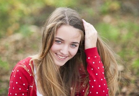 Outdoor portrait of beautiful young girl smilingの写真素材