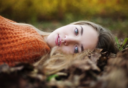 Outdoor portrait of beautiful girl in autumn forestの写真素材