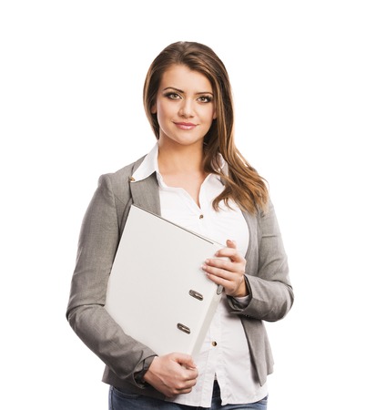 Successful business woman is standing with file folder on isolated backgroundの写真素材
