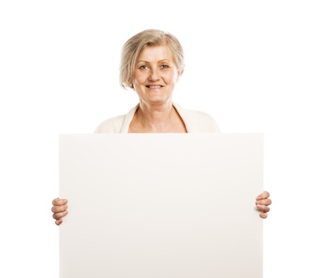 Portrait of happy senior woman with blank advertising board or copy space, isolated on white