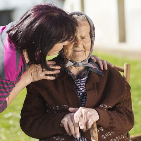 Senior woman with daughter taking care of her