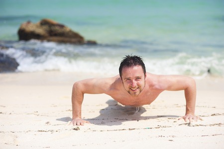 Handsome young man exercising at paradise beach in Phu quoc island, south of vietnam
