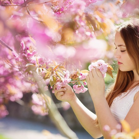 Beautiful girl smells the flower の写真素材