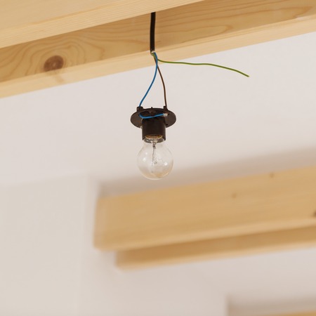 Hanging transparent glass bulb from unfinished construction の写真素材