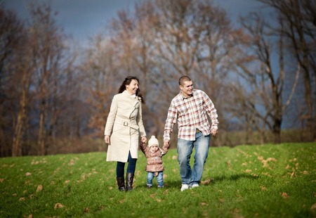 Happy and young family relaxing together in autum natureの写真素材