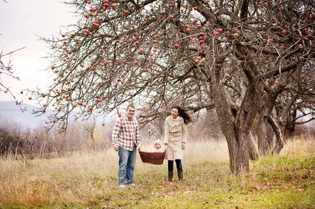 Happy and young family relaxing together in autum natureの写真素材