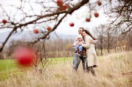 Happy and young family relaxing together in autum natureの写真素材