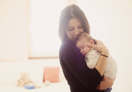 Young mother is holding her little baby Young mother is holding her little baby