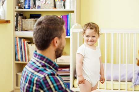 happy father and his little daughter playing at homeの写真素材