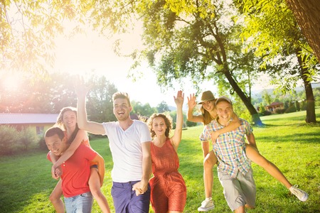 Group of five teenage friends having fun in parkの写真素材