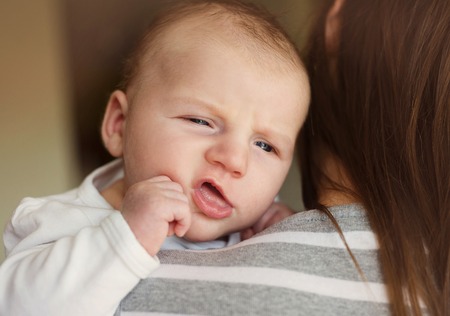 Newborn baby boy is tired and sleepy