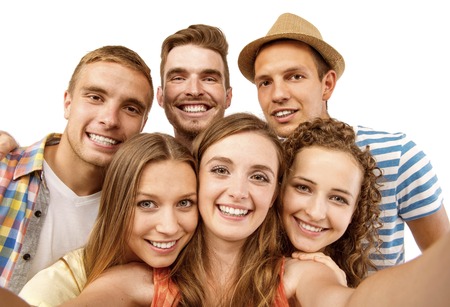 Group of happy young teenager students taking selfie photo isolated on white background